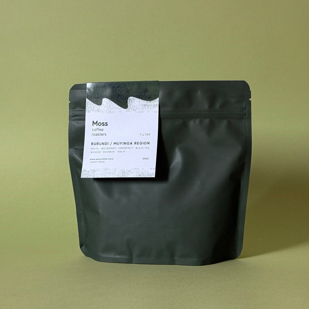 A matte black stand-up pouch of Moss Coffee Roasters on a solid olive green background.
